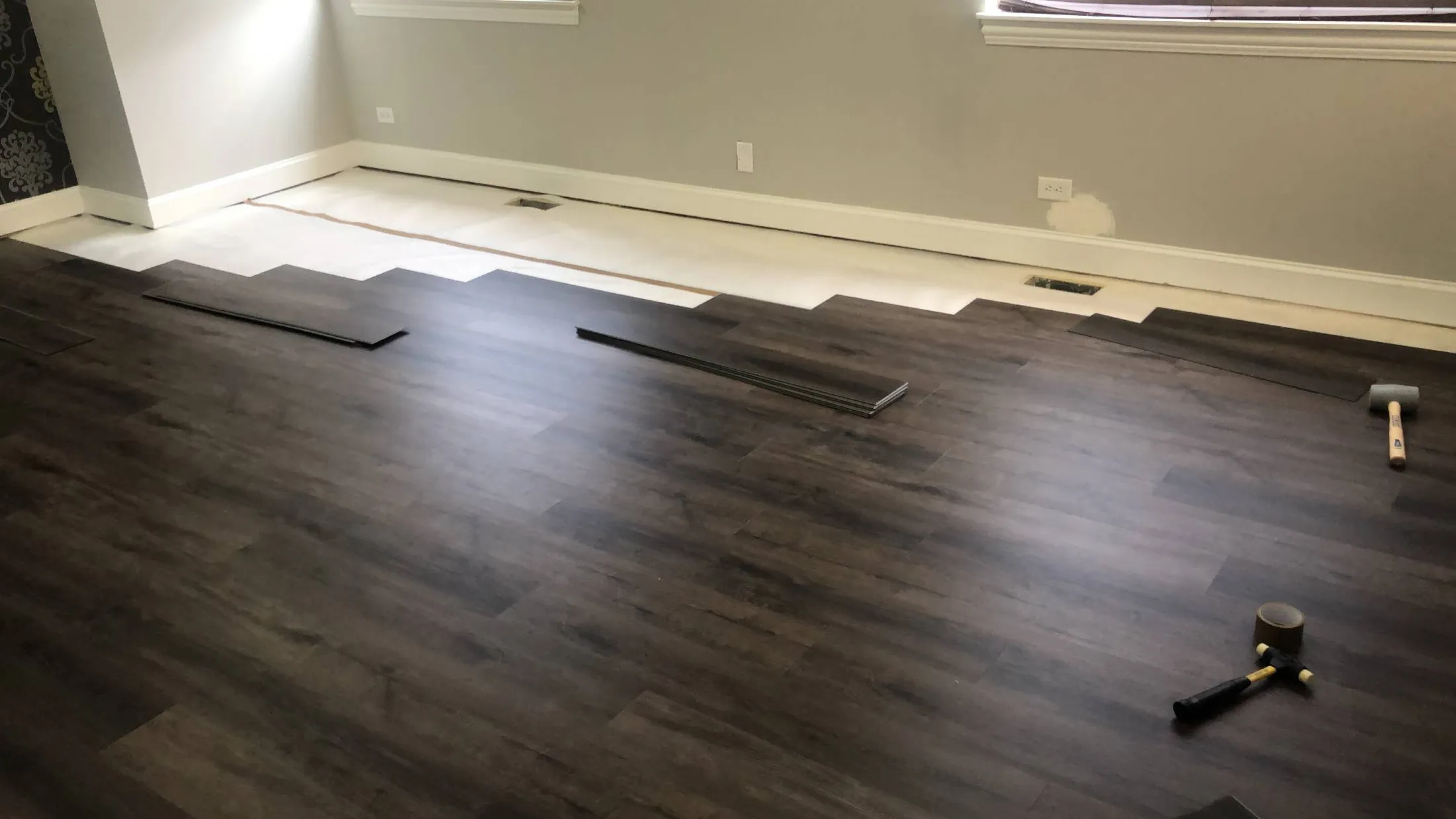 Installing dark plank flooring, mid-job